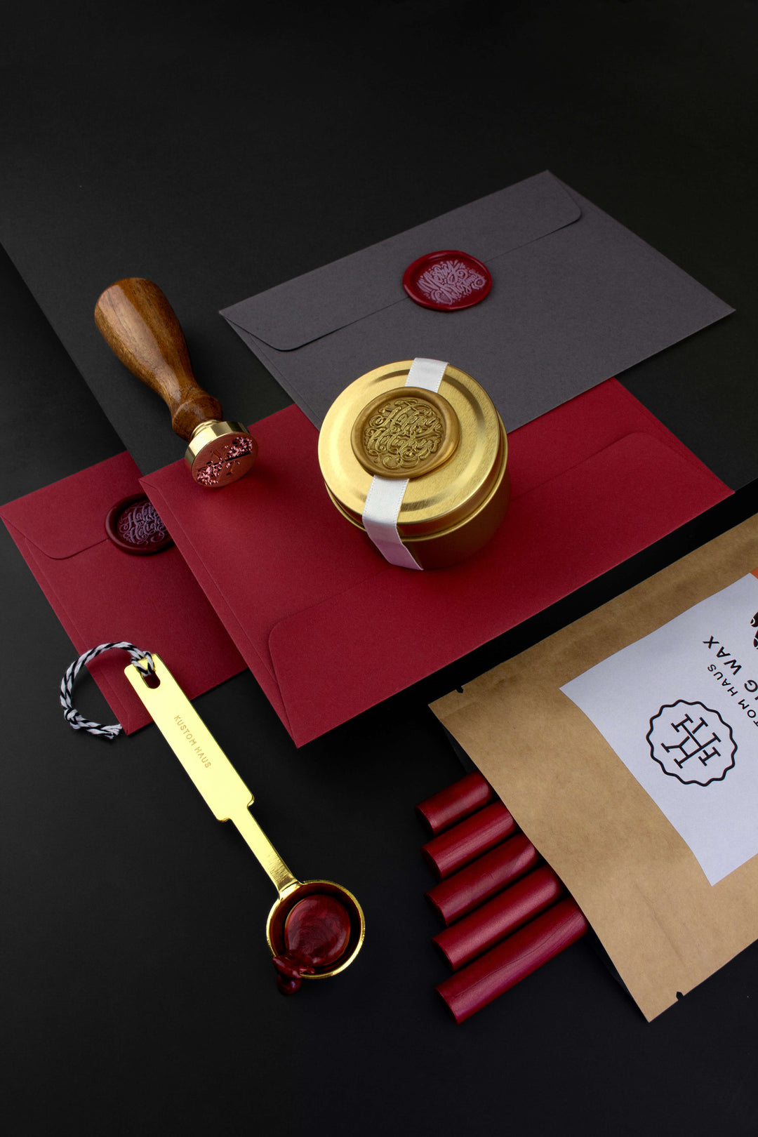 Christmas-themed Wax Seal Stamp and Sealing Wax with Red Envelopes and a Gold Melting Spoon.